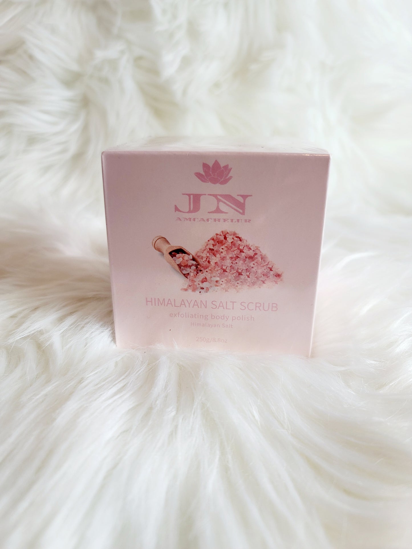 JNA Himalayan salt body scrub in pink packaging.