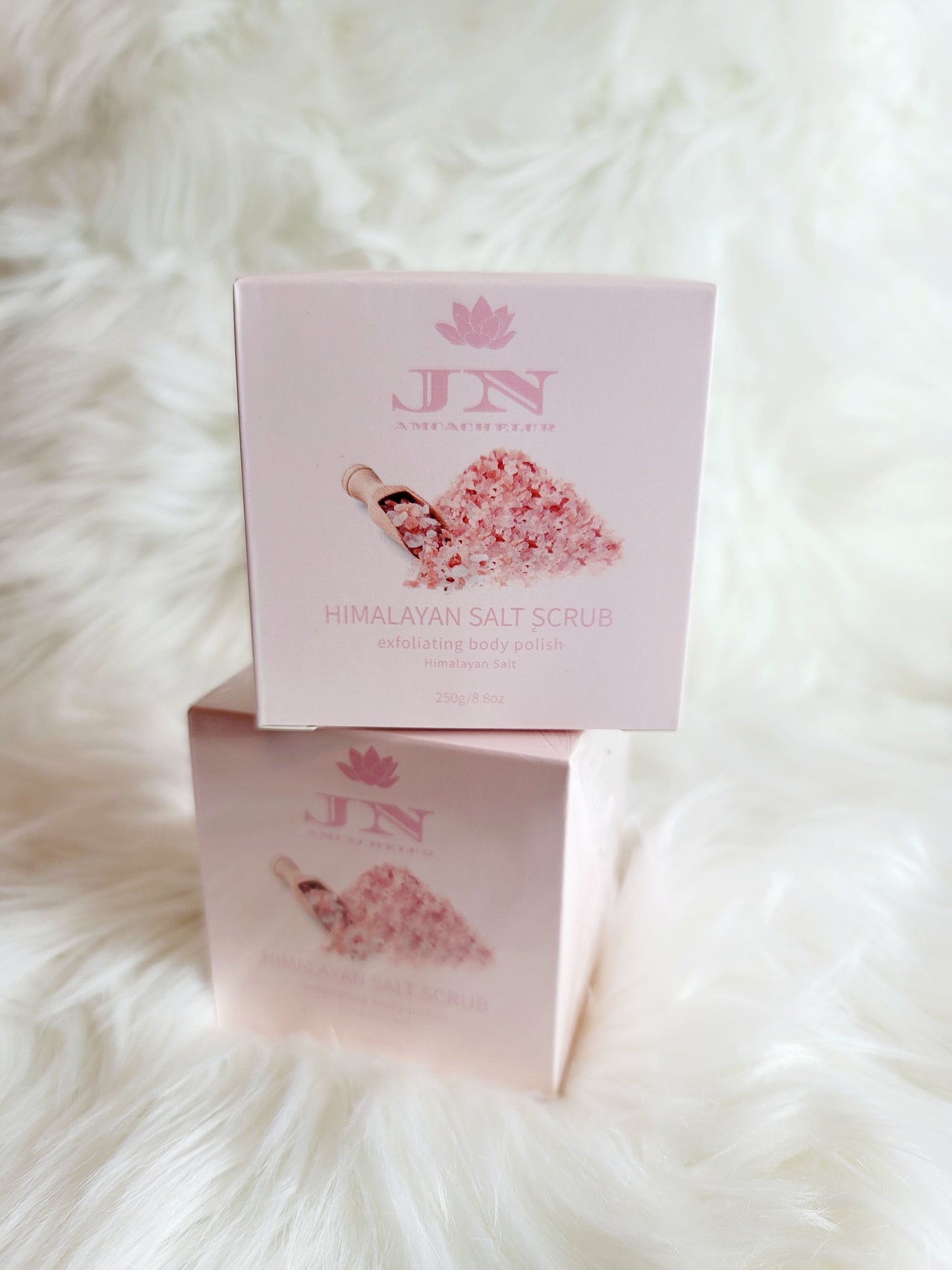 JNA Himalayan salt body scrub in pink packaging.