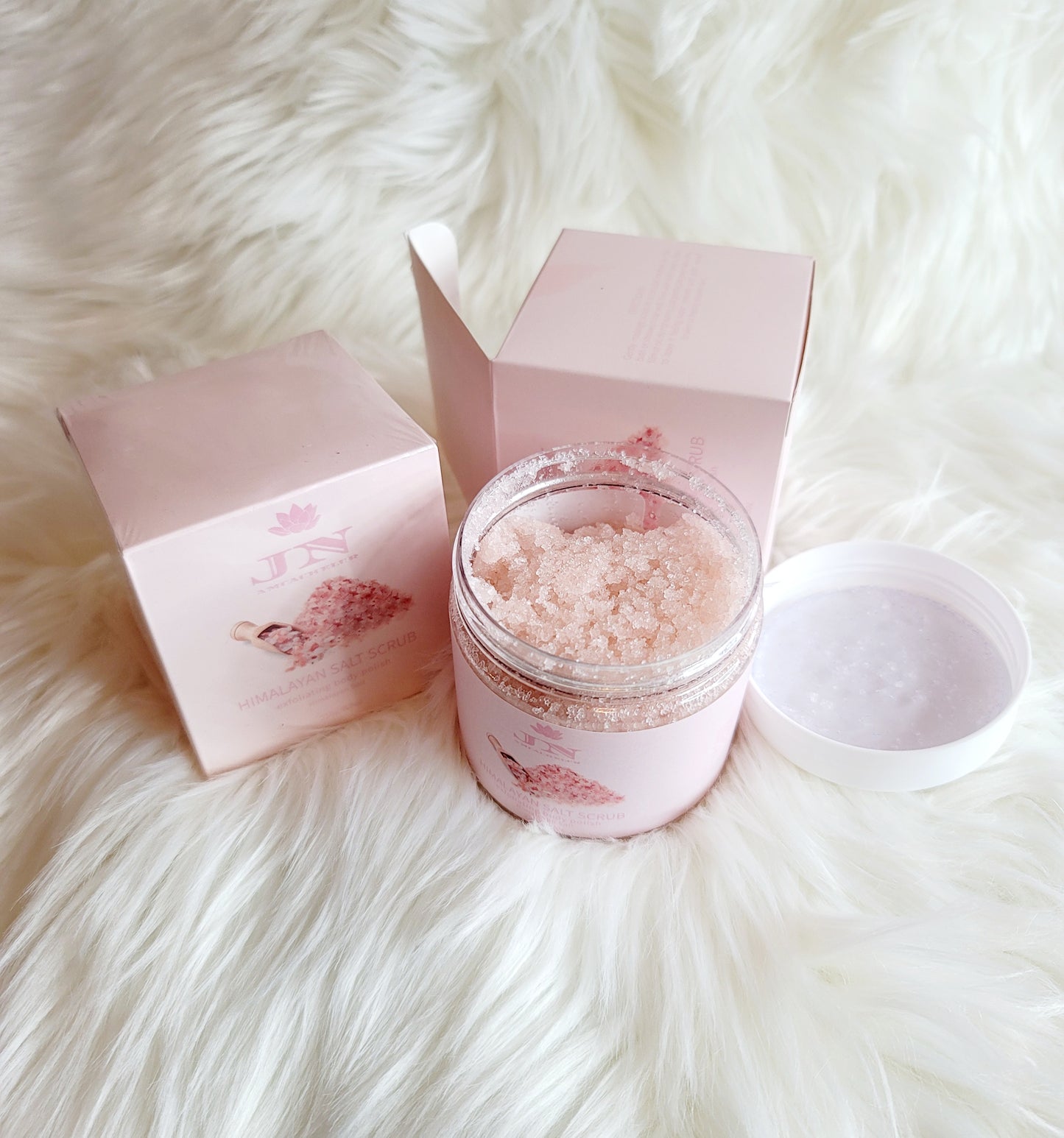 JNA Himalayan salt body scrub in pink packaging.