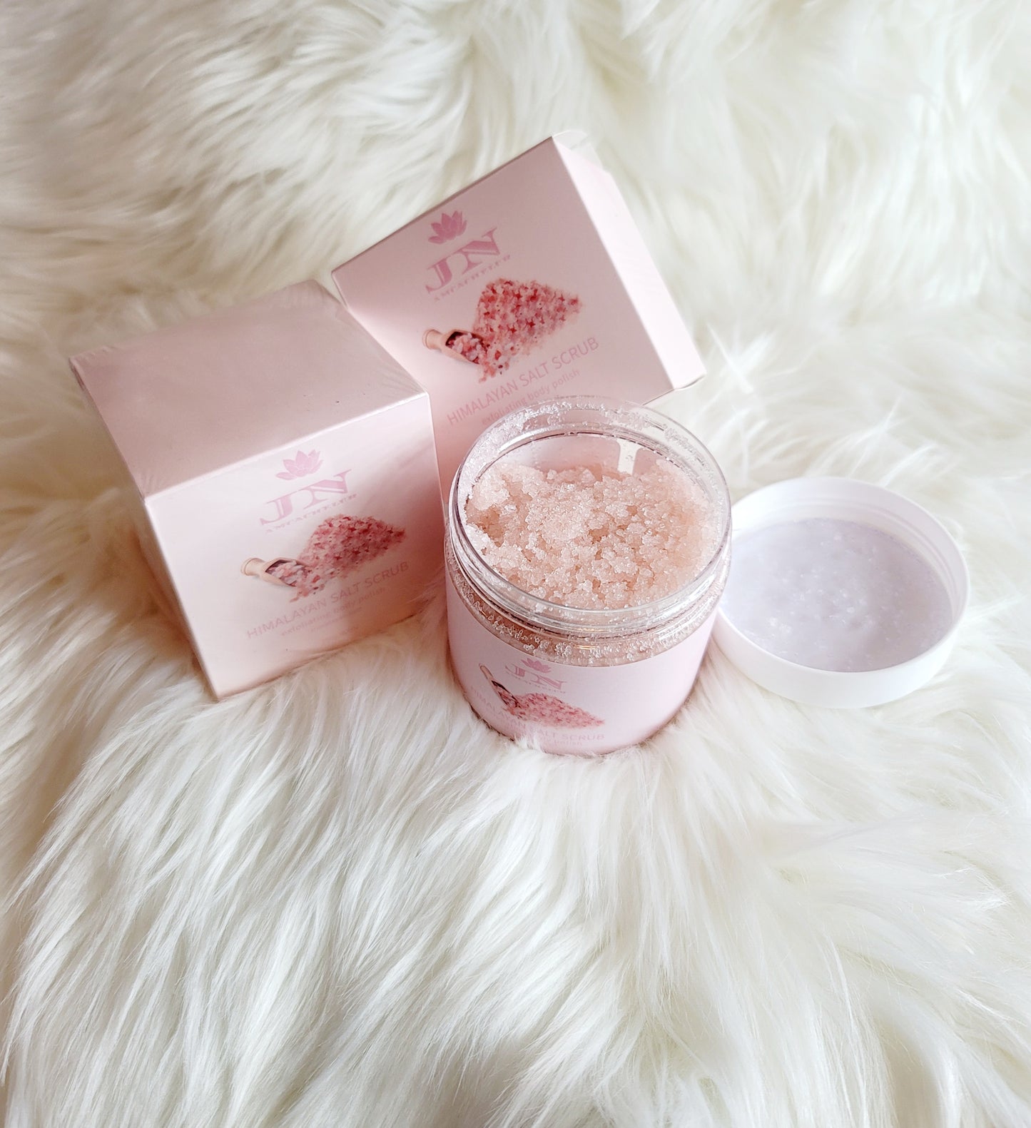 JNA Himalayan salt body scrub in pink packaging.