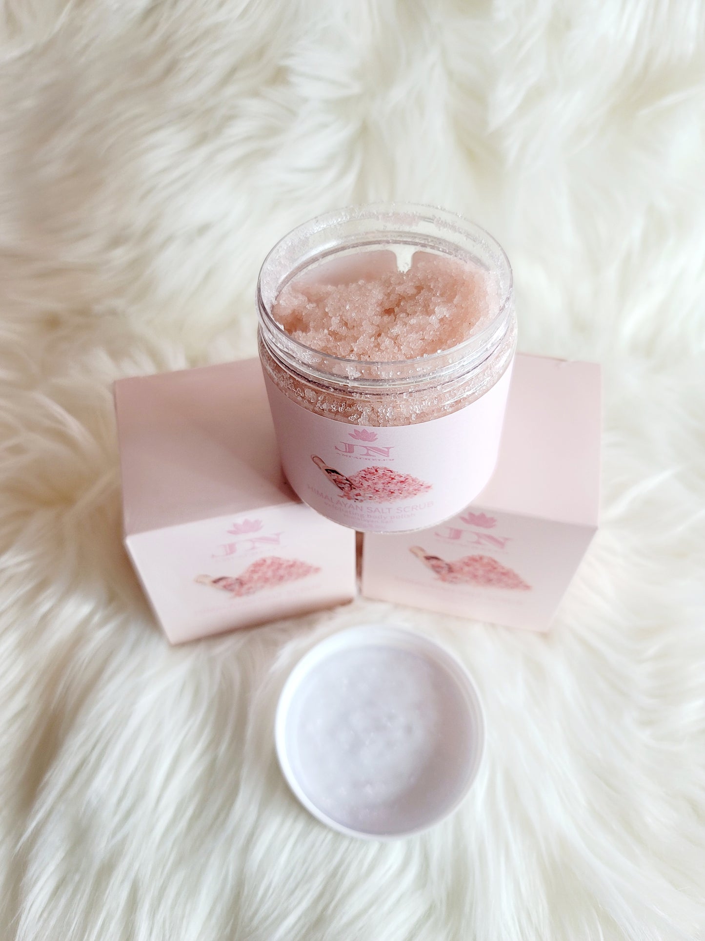 JNA Himalayan salt body scrub in pink packaging.