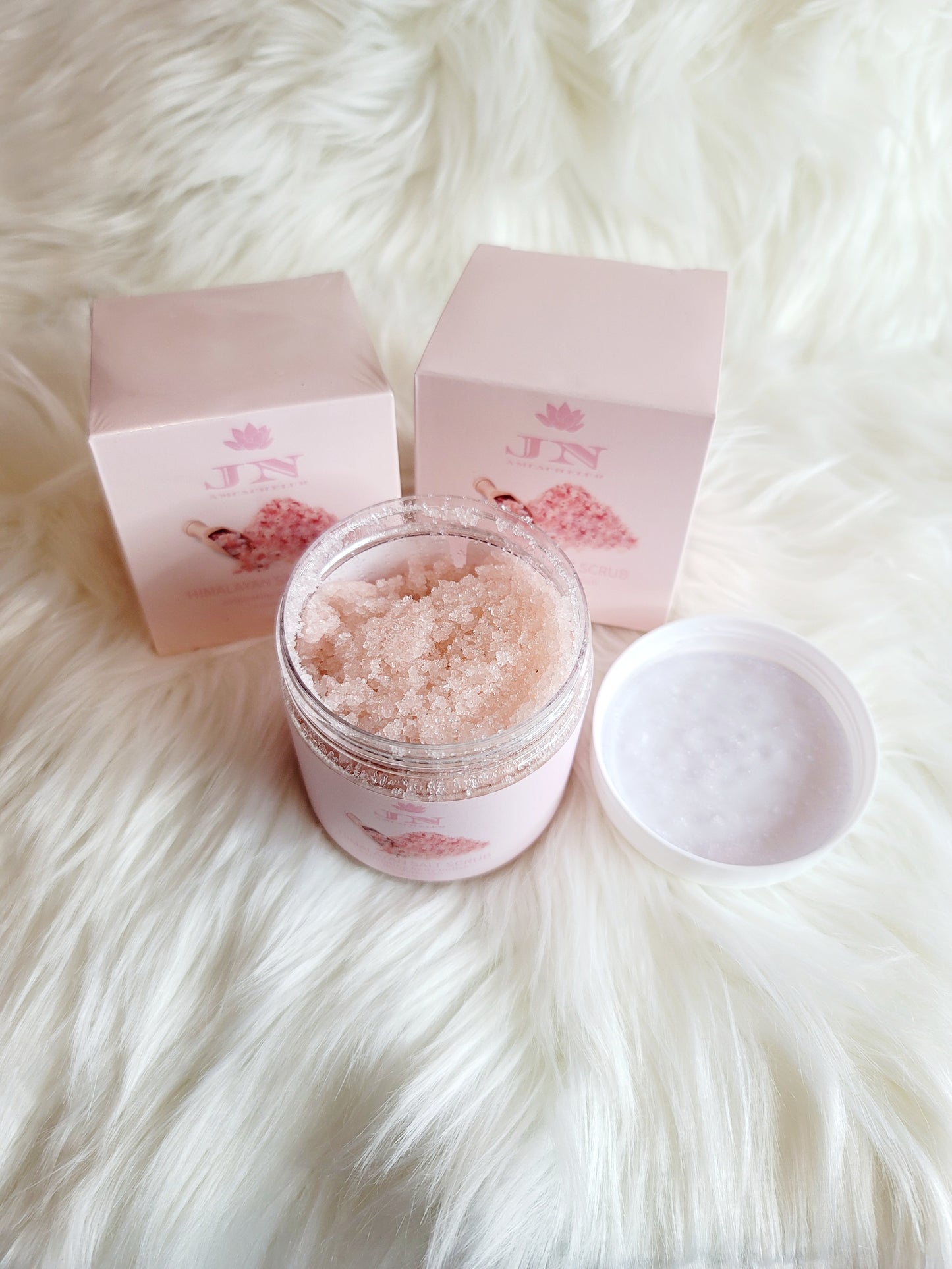 JNA Himalayan salt body scrub in pink packaging.