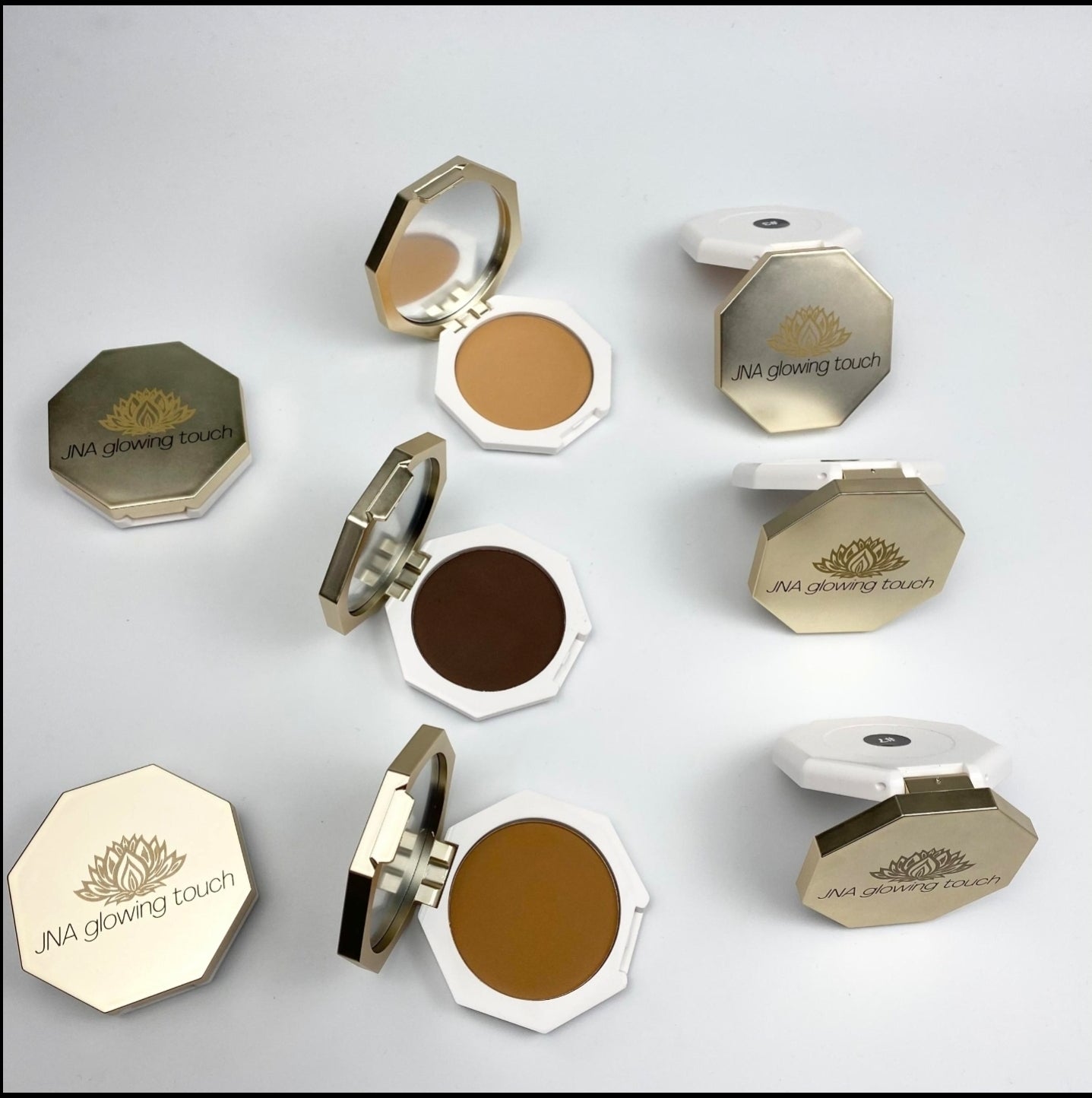 Various color options of JNA Glowing Touch golden compact powder foundation.