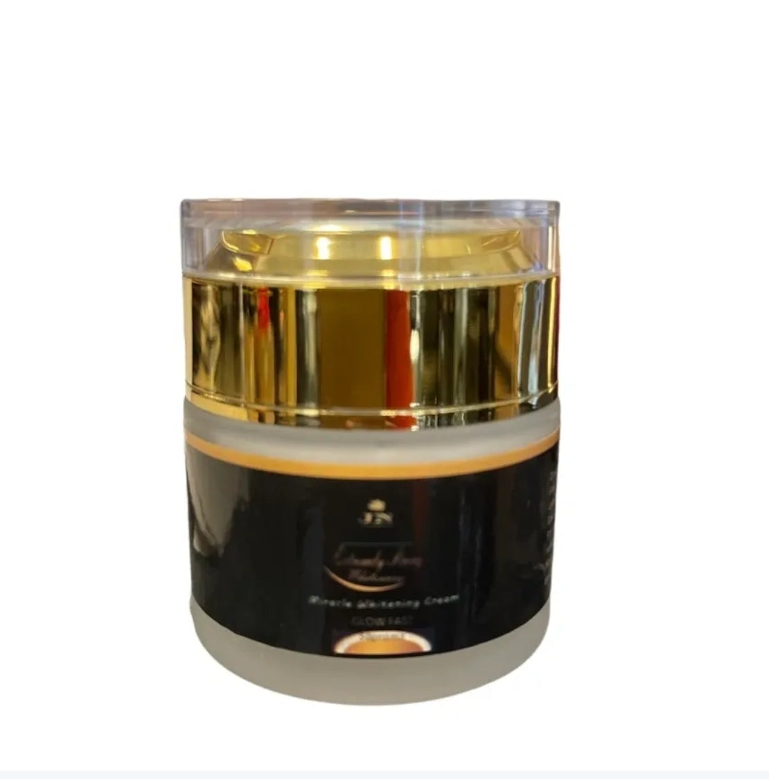 JNA glowing touch face cream in a gold jar displayed .