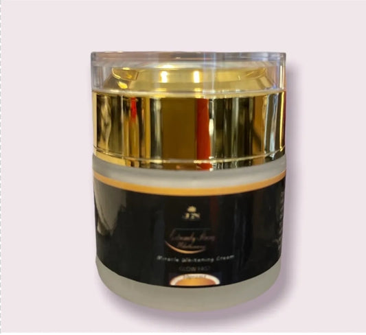 JNA glowing touch face cream in a gold jar displayed .