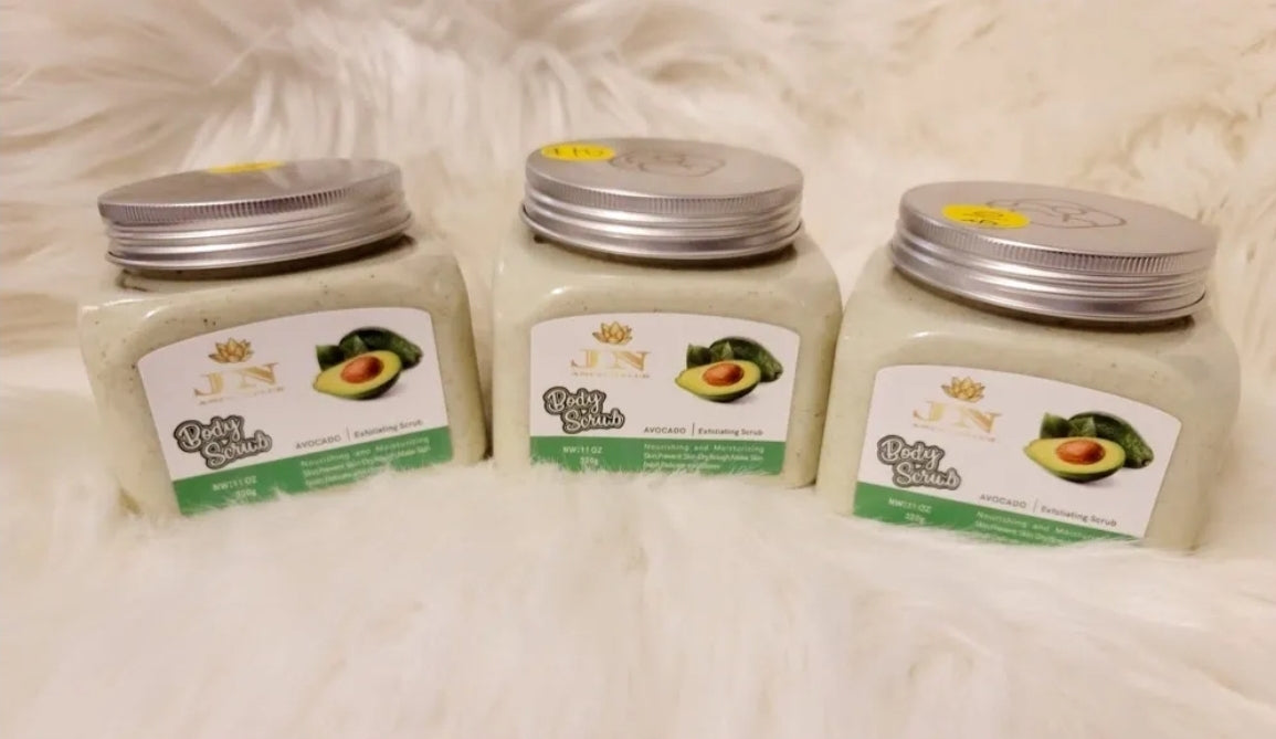 Three containers of JNA avocado body scrub sets displayed.