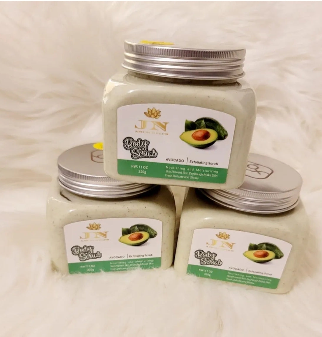 Three containers of JNA avocado body scrub sets displayed.