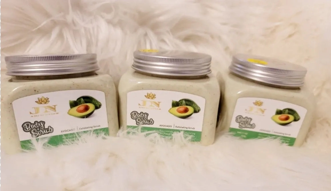 Three containers of JNA avocado body scrub sets displayed.