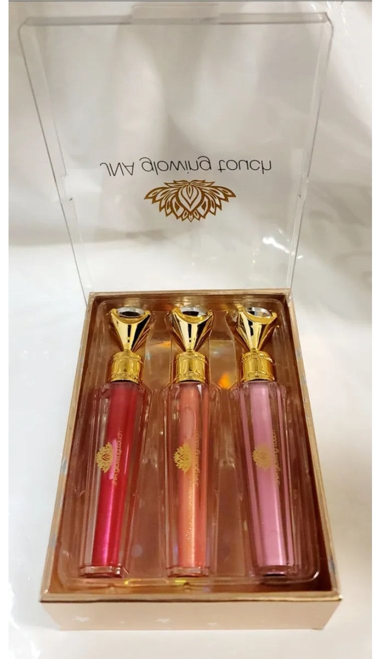 Luxury set of JNA glowing touch lipgloss in a gold box.