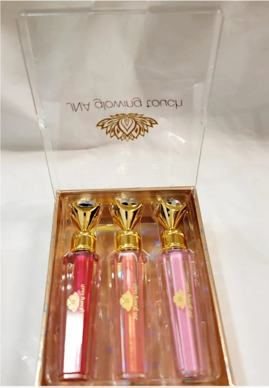 Luxury set of JNA glowing touch lipgloss in a gold box.