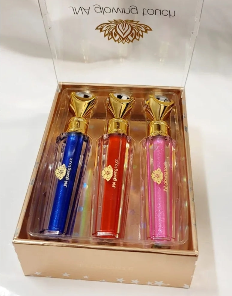 Luxury set of JNA glowing touch lipgloss in a gold box.