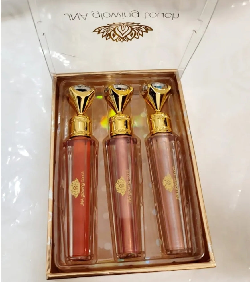 Luxury set of JNA glowing touch lipgloss in a gold box.