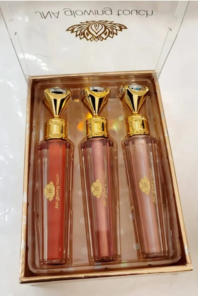 Luxury set of JNA glowing touch lipgloss in a gold box.