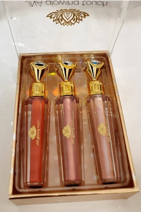 Luxury set of JNA glowing touch lipgloss in a gold box.