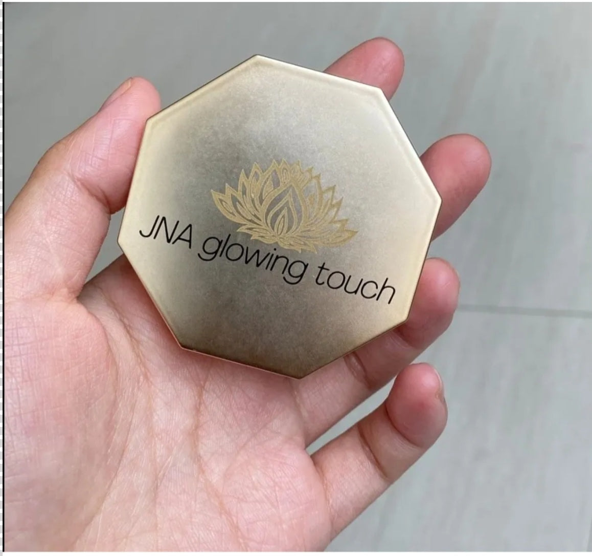 JNA glowing touch highlighter set in gold and bronze compact form.