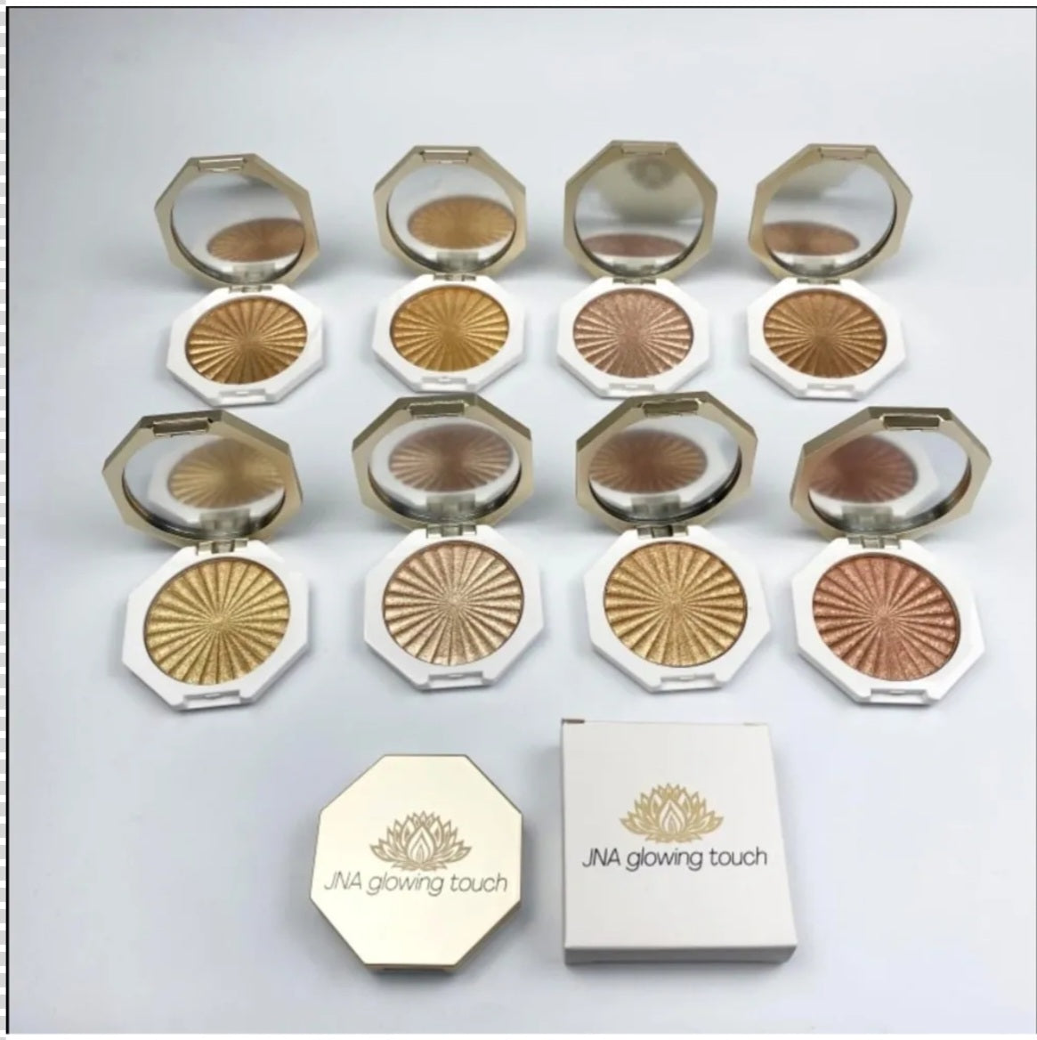 JNA glowing touch highlighter set in gold and bronze compact form.