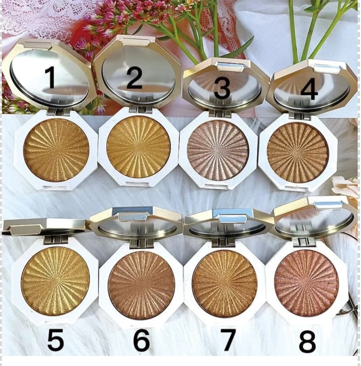 JNA glowing touch highlighter set in gold and bronze compact form.