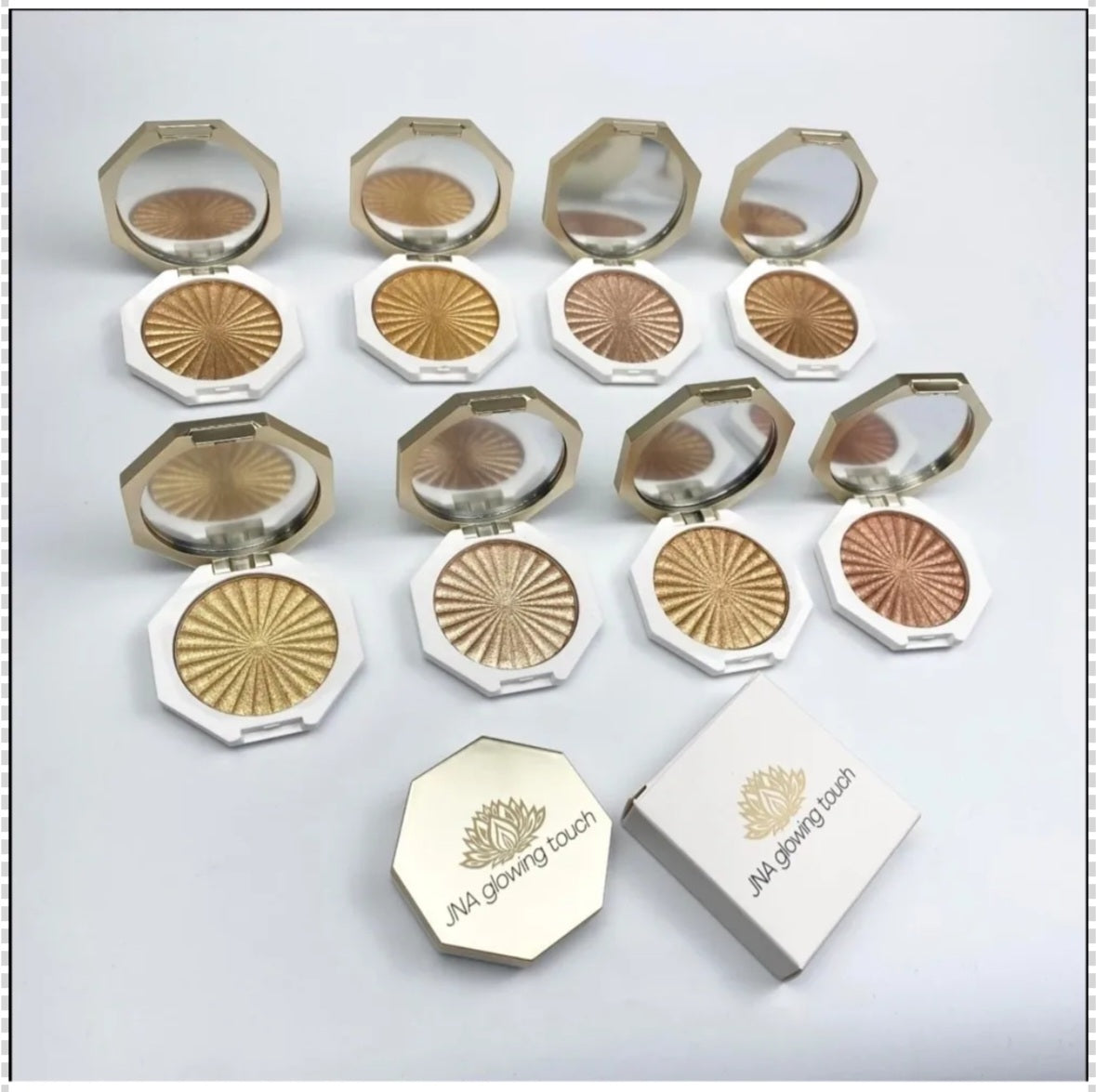 JNA glowing touch highlighter set in gold and bronze compact form.